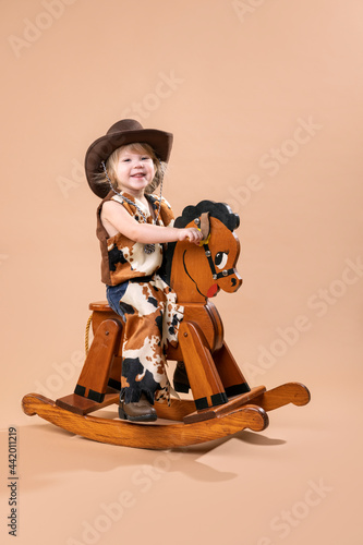 2 year old toddler playing make believe cowboy