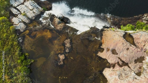 Aerial view of water cascading at a beautiful waterfall in the Mkambati Nature Reserve, Eastern Cape, South Africa photo