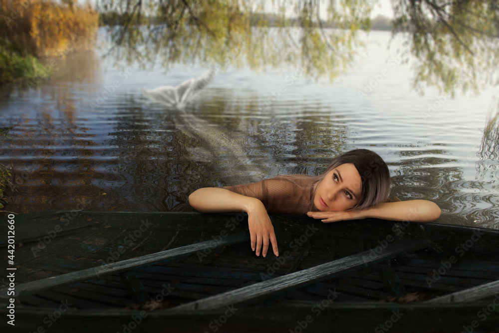 Fototapeta premium bored mermaid in the lake