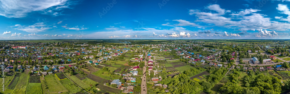 over the streets of the district center - the working village Tokarevka (Tamabov region, center of Russia) - a large aerial panorama on a sunny summer day