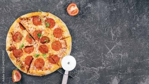 pepperoni pizza on dark concrete surface top view, place for copy space