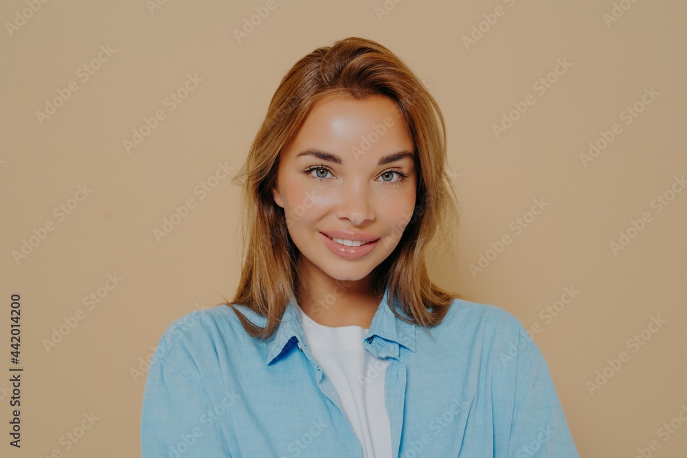Headshot portrait of happy brunette model female in blue shirt Headshot portrait of happy brunette model female in blue shirt