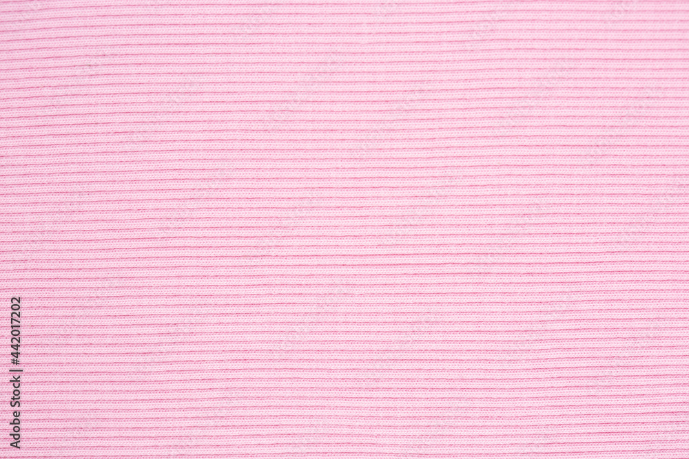 Fototapeta premium Pink knitted background. Knitted texture. Knitting pattern of wool. Knitting. Texture of knitted woolen fabric for wallpaper and an abstract background