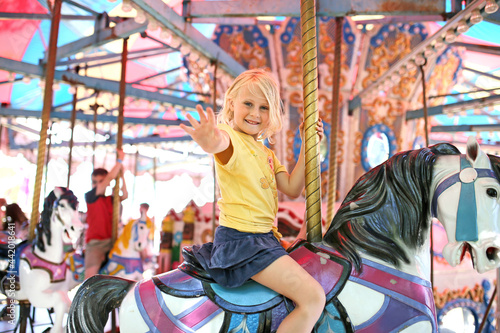 Happy Little Child On Merry Go Round Horse at Carnival