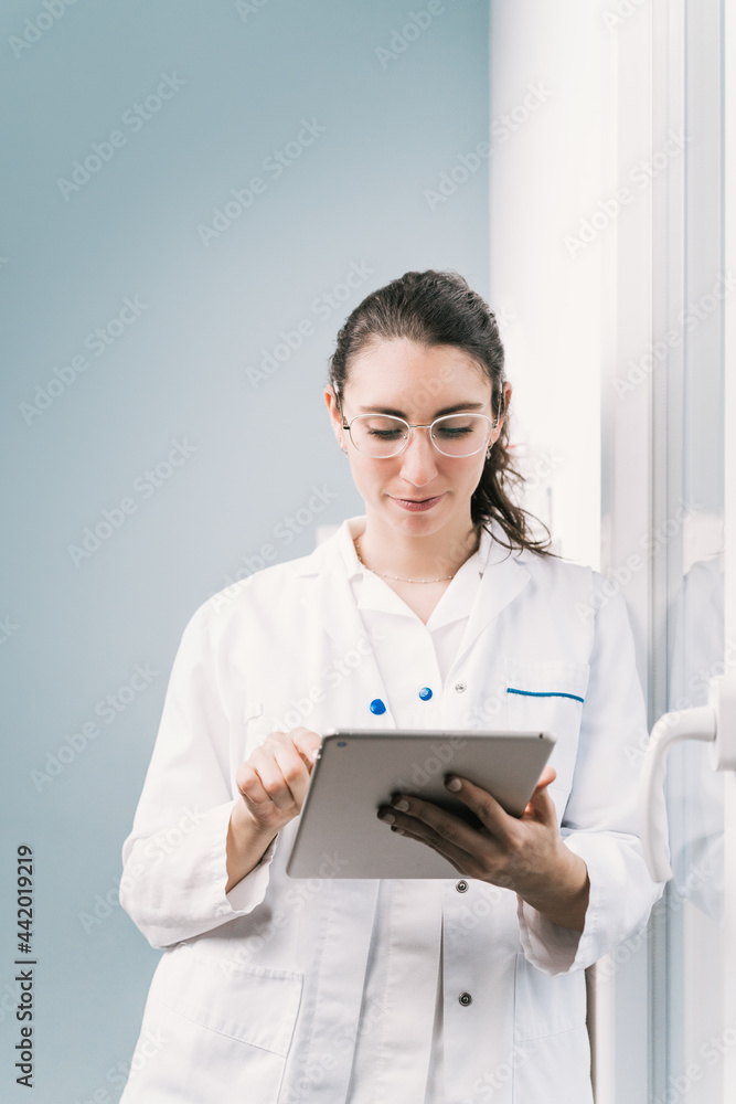 Nurse in uniform working on tablet in hospital Nurse in uniform working on tablet in hospital