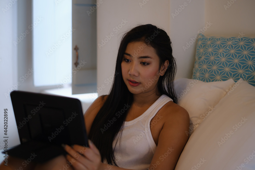 A woman lying on couch and using tablet. Work from home concept A woman lying on couch and using tablet. Work from home concept