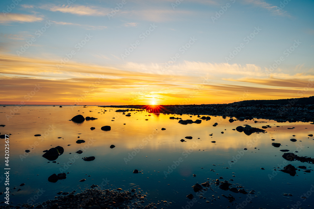 Summer sunset over stone beach in Helsingborg, Sweden.