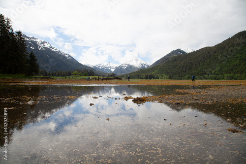 Hikers cross tide pool in Alaska