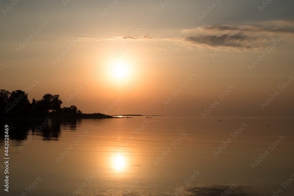 Amazing orange golden sunset over the sea. Summer sunset at the Baltic sea, Europe. Amazing orange golden sunset over the sea. Summer sunset at the Baltic sea, Europe.