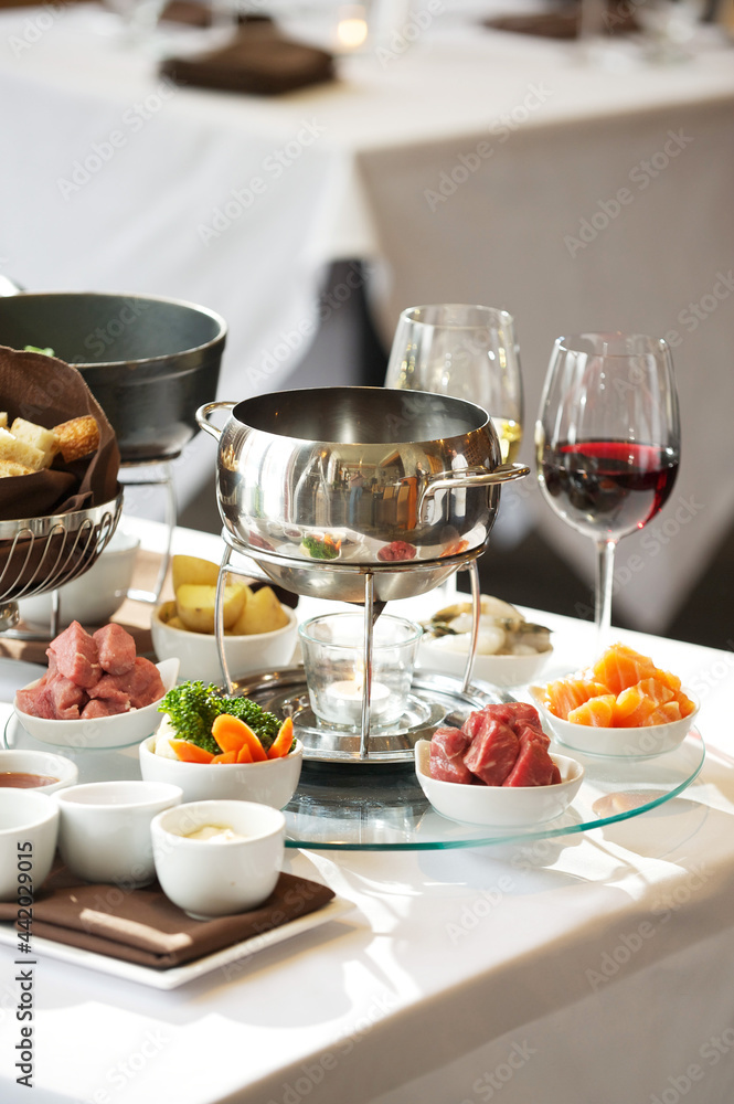 Fondue plate at a restaurant. Cheese, traditional oil, and chocolate fondue Fondue plate at a restaurant. Cheese, traditional oil, and chocolate fondue