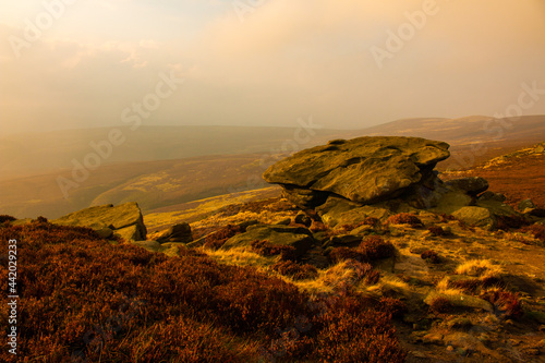 Hiking the rocky path around Ladybower Reservoir at sunset in the fog, Peak District, Derbyshire, England