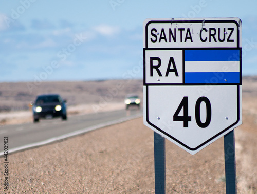 Route 40 sign in Santa Cruz, Argentina, with cars coming from the front.