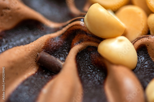 Macro close up on a profiterol ice cream with vanilla and chocolate 