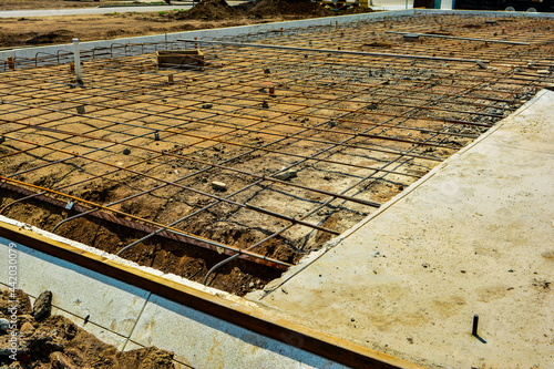 Reinforcement rod and wood forms ready for concrete pour for second half of slab of new commercial building. photo