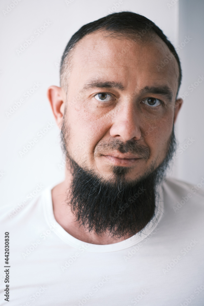 Happy muslim man with beard dressed in white t-shirt is Looking at camera Happy muslim man with beard dressed in white t-shirt is Looking at camera