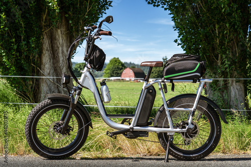 Moped Style Electric Bike with a Country Pasture and Barn in Background