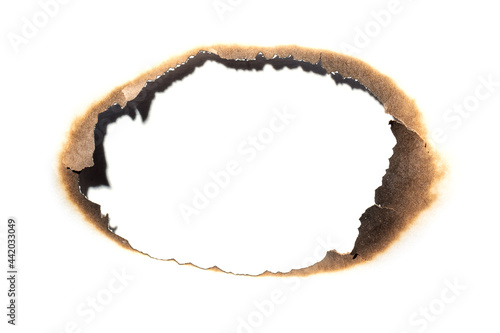 Fire burned hole white paper background texture. Paper burn mark stain