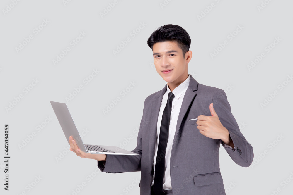 Young asian business man standing work on laptop computer to internet online isolated on white background, businessman confident and notebook, freelance with success, marketing and communication. Young asian business man standing work on laptop computer to internet online isolated on white background, businessman confident and notebook, freelance with success, marketing and communication.