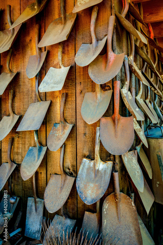 shovel heads on a wooden wall