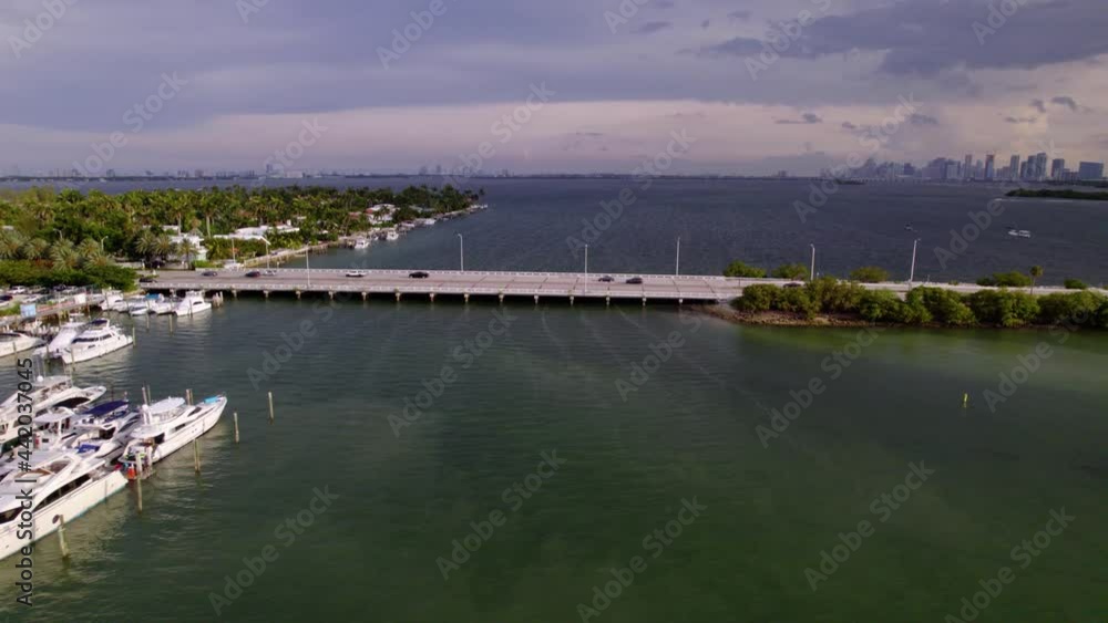 Aerial view around cars on a bridge, in sunny Miami, Florida - circling, drone shot Aerial view around cars on a bridge, in sunny Miami, Florida - circling, drone shot