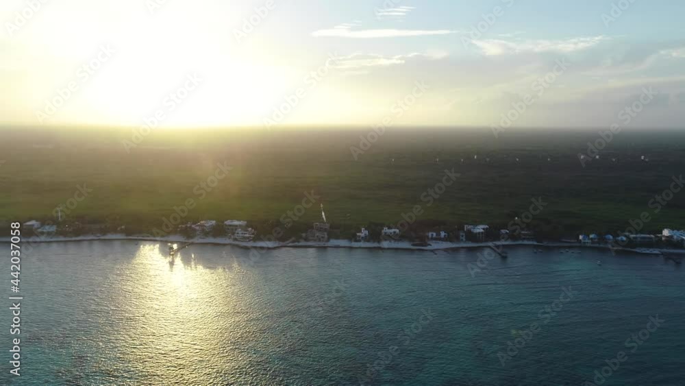 Aerial View of Coastline in Tulum, Mexico With Sun Setting in Background Aerial View of Coastline in Tulum, Mexico With Sun Setting in Background