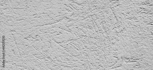 Detailed fragment of gray scratched cement wall. Gray background, texture. ..
