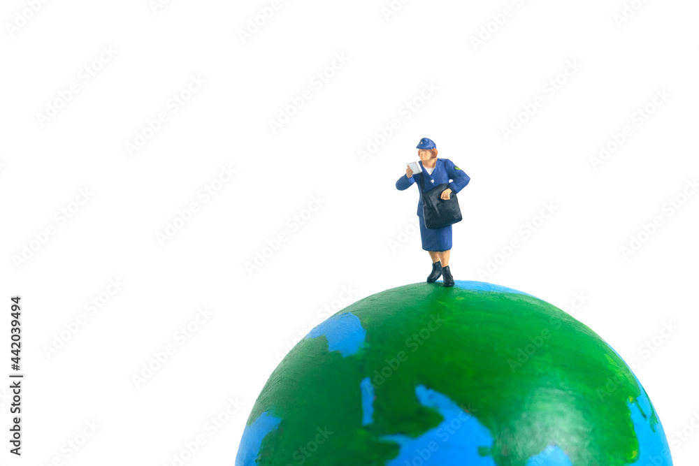 Miniature people toys conceptual photography. Global, international delivery service. Postman, courier standing above earth globe. Miniature people toys conceptual photography. Global, international delivery service. Postman, courier standing above earth globe.