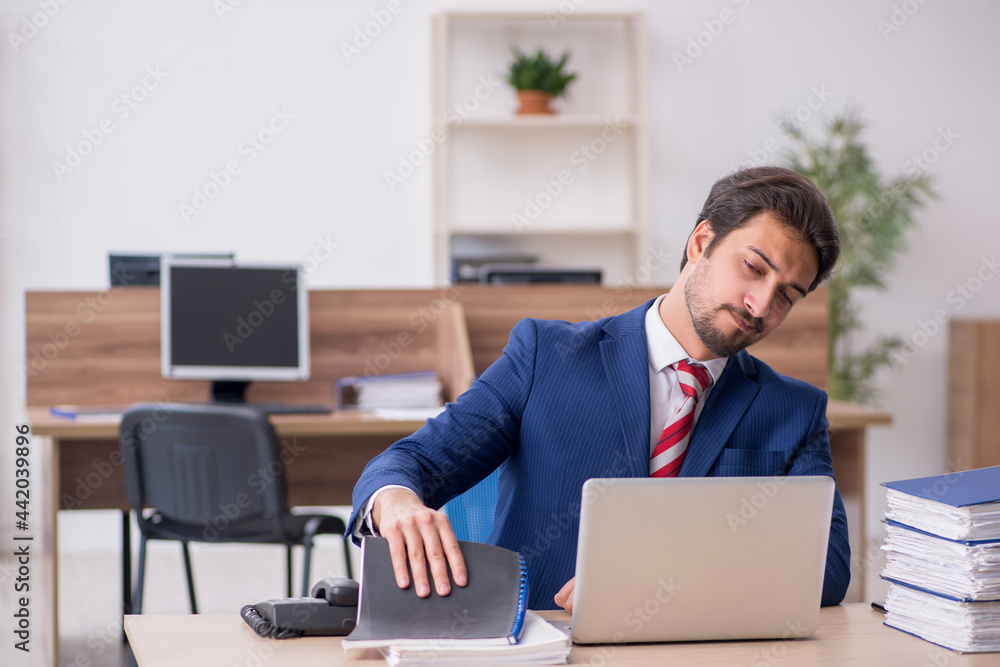 Young male employee working in the office Young male employee working in the office