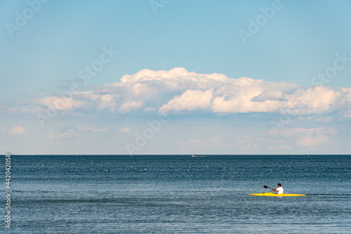 Clouds and water lake Ontario. White blue small clouds on the sky near water coast in Toronto. Summer mood vibes. Sunny leisure after lock down. Relaxing background. © desertsands