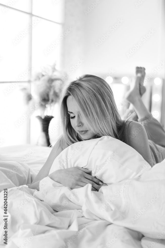 morning girls: a blonde in a blanket sitting on the bed. waking up from a dream. just woke up morning girls: a blonde in a blanket sitting on the bed. waking up from a dream. just woke up