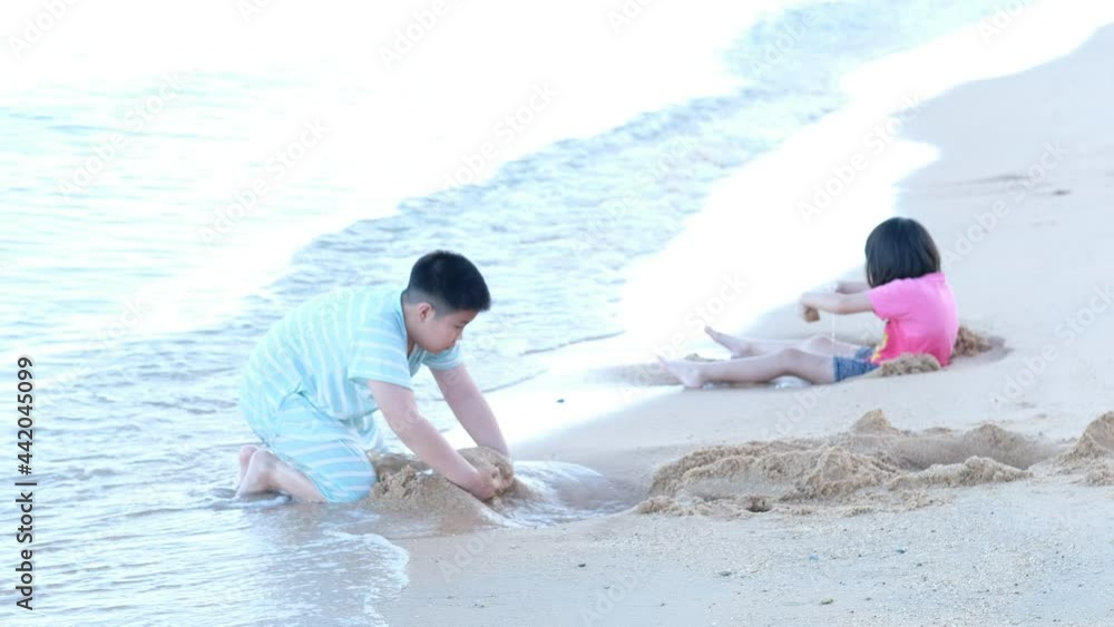 kid playing sand on the beach, Children playing in the sea
kid playing sand on the beach, Children playing in the sea