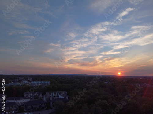 Aerial photos of a beautiful sunset with white clouds and blue sky over the river © CELINE BISSON PHOTOS
