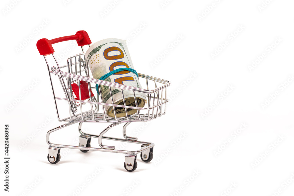 shopping cart with 100 dollars banknotes on white background
