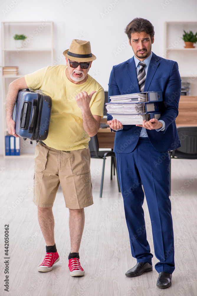 Old boss and young male employee in summer vacation concept Old boss and young male employee in summer vacation concept