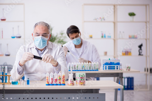 Two male chemists in drugs synthesis concept at the lab
