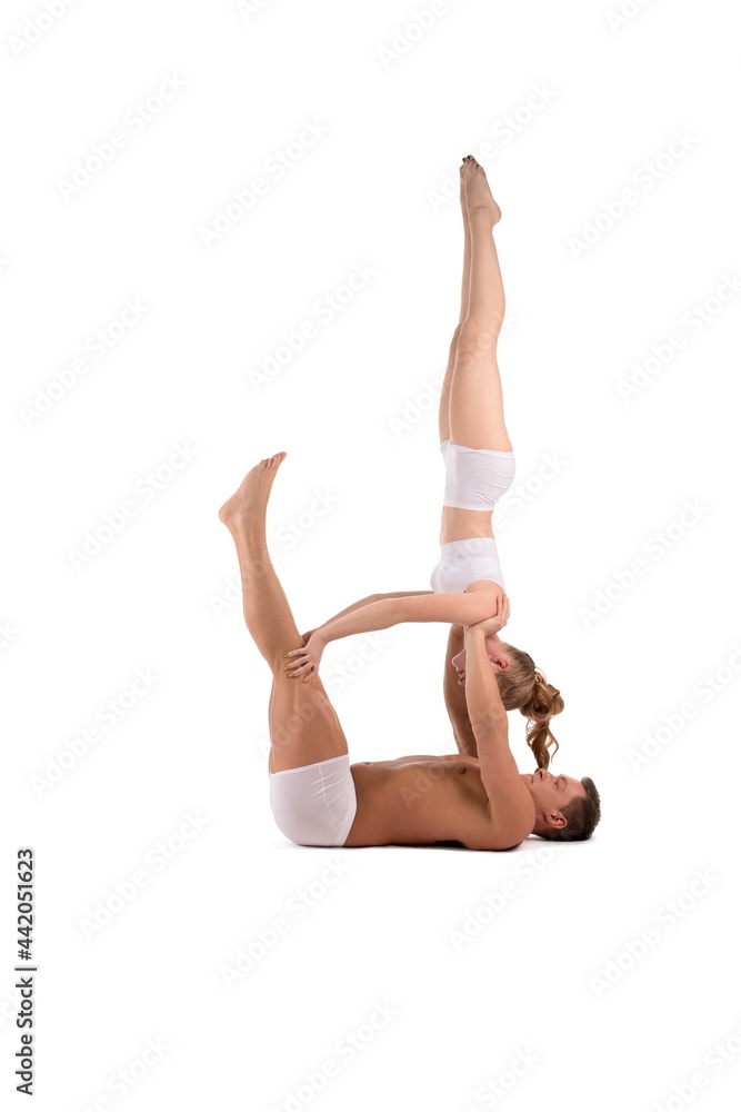 Young couple doing acrobatic exercise in studio Young couple doing acrobatic exercise in studio