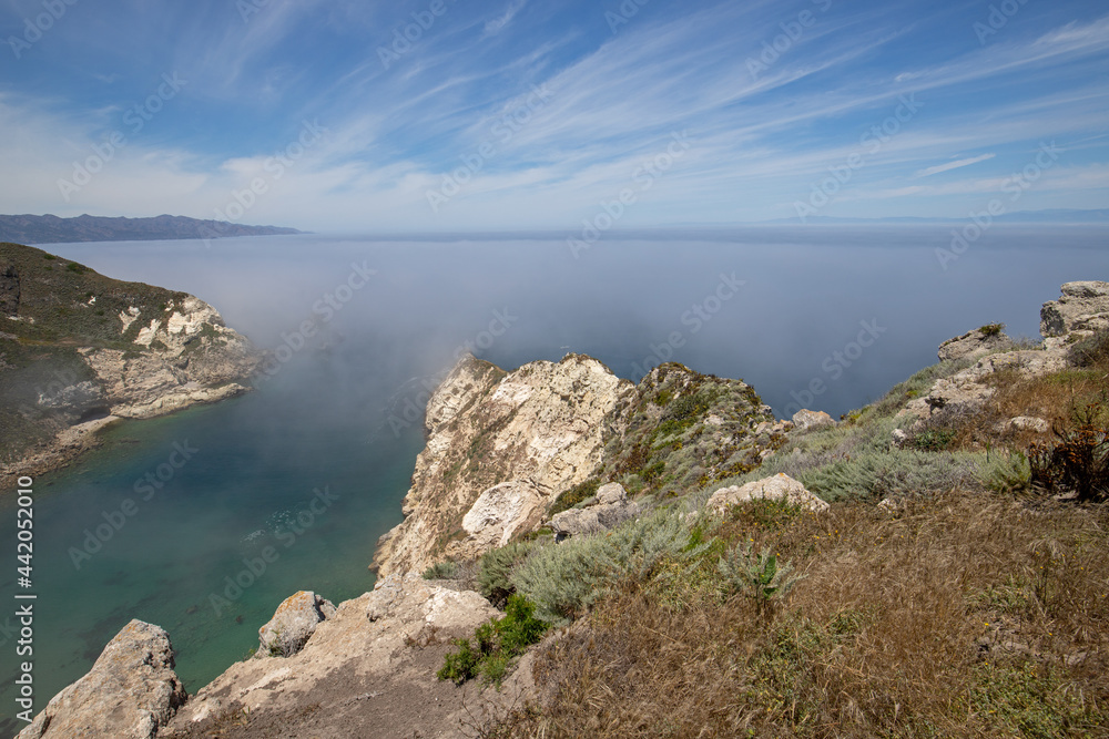 Potato Harbor on Santa Cruz Island with mist coming in under blue cirrus sky in the Channel Islands National Park offshore from Santa Barbara California USA