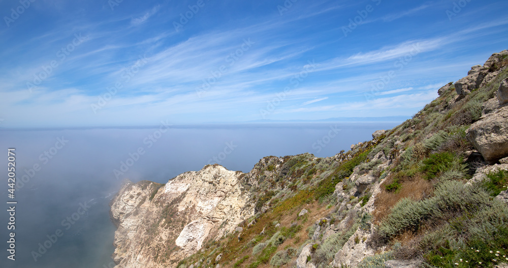 Potato Harbor on Santa Cruz Island with mist coming in under blue cirrus sky in the Channel Islands National Park offshore from Santa Barbara California USA Potato Harbor on Santa Cruz Island with mist coming in under blue cirrus sky in the Channel Islands National Park offshore from Santa Barbara California USA