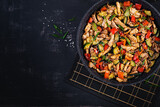 Stir fry with chicken, zucchini and sweet peppers - Chinese food. Top view, above