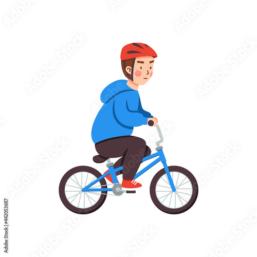Cute kid boy in safety helmet riding a bicycle, child with two wheel bike.