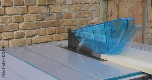 Handy man cutting wood on a table saw. Carpentry wood work.	