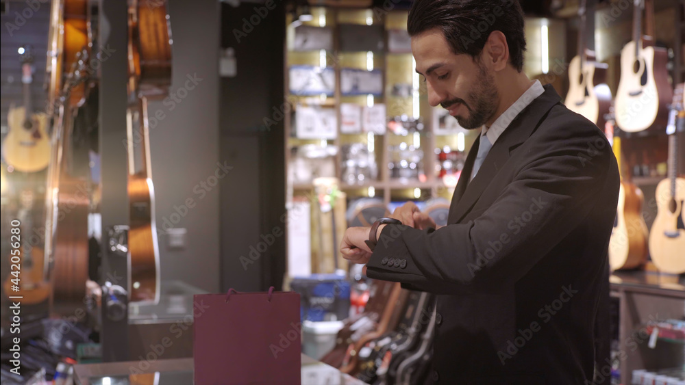An upwardly mobile Muslim man using smart payment to pay for a product at a sale terminal with nfc identification payment for verification and authentication An upwardly mobile Muslim man using smart payment to pay for a product at a sale terminal with nfc identification payment for verification and authentication