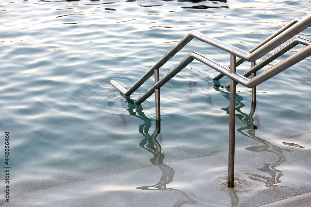 Close-up of sea pool and railings on dusk Close-up of sea pool and railings on dusk