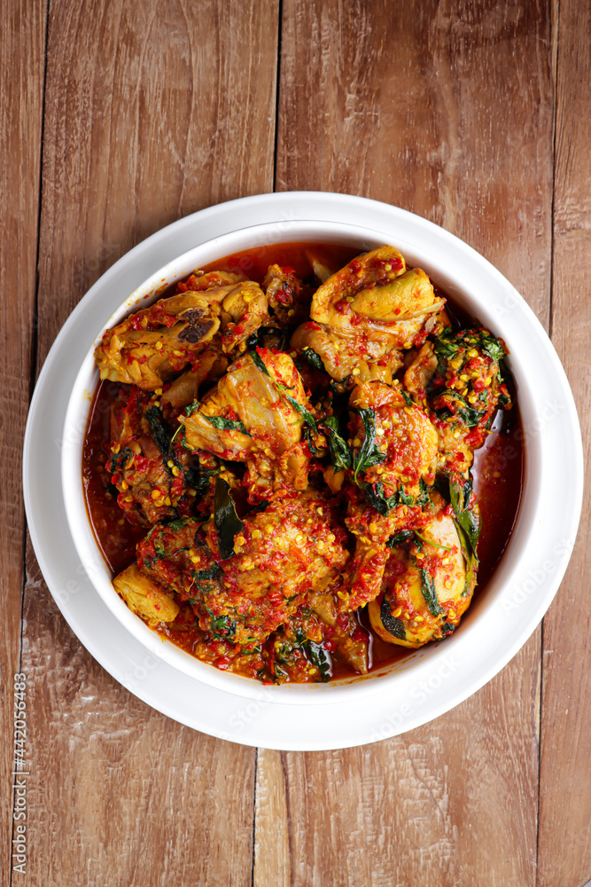 Ayam Rica-Rica. Traditional dish from Manado, Indonesia, braised chicken in spicy paste and garnish with lemon basil. Ayam Rica-Rica. Traditional dish from Manado, Indonesia, braised chicken in spicy paste and garnish with lemon basil.