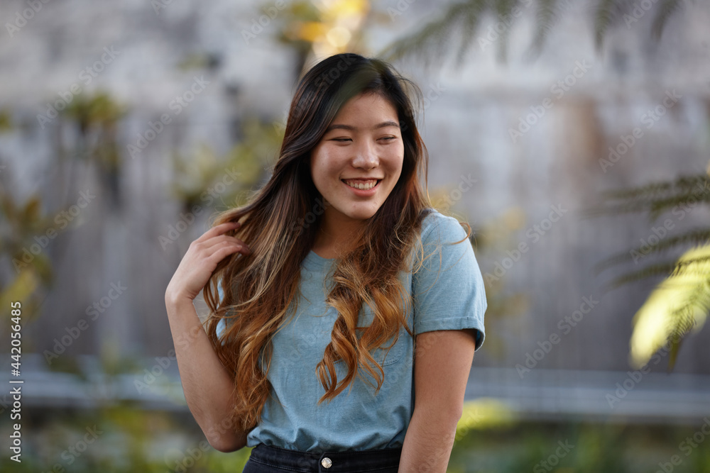 Young Asian woman enjoying time outdoors at enclave Young Asian woman enjoying time outdoors at enclave