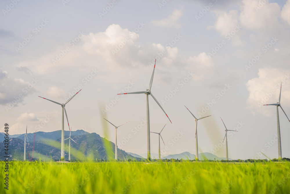 Wind power plant. green meadow with Wind turbines generating electricity Wind power plant. green meadow with Wind turbines generating electricity