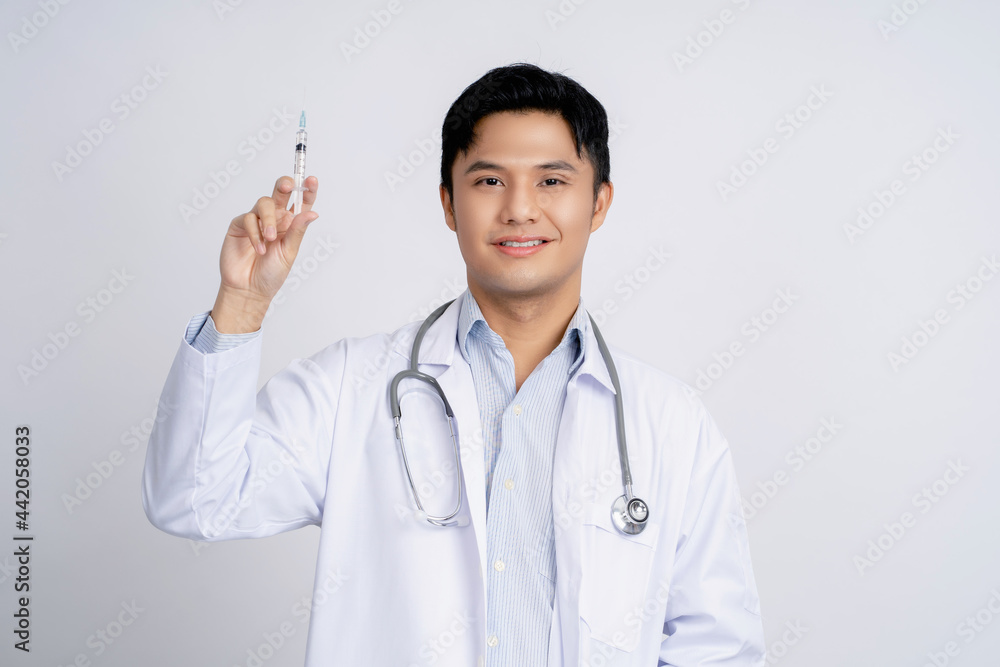 Portrait of a handsome Asian male doctor holding a syringe on isolated background. Portrait of a handsome Asian male doctor holding a syringe on isolated background.