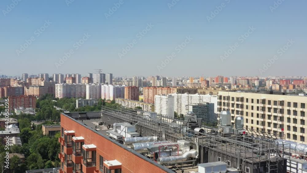 New modern designer brick apartment building in a modern residential complex in the summer. aerial view New modern designer brick apartment building in a modern residential complex in the summer. aerial view