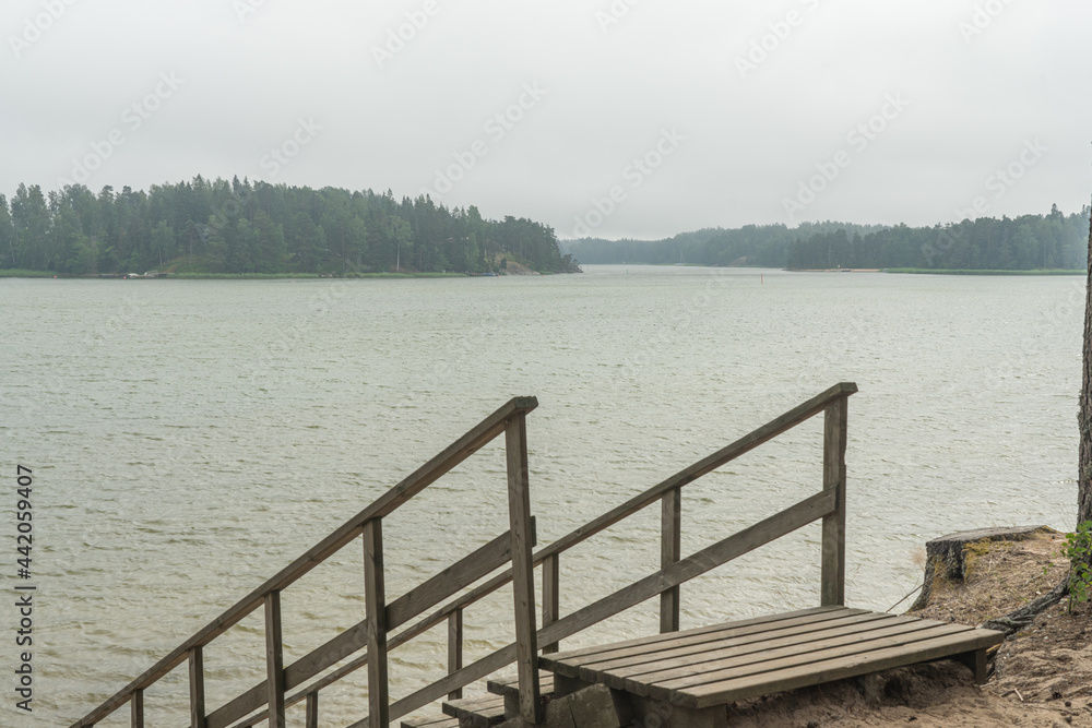 Wooden stairs to the seashore. Sandy beach, pine forest. Scandinavian nature. Finland. Porvoo Wooden stairs to the seashore. Sandy beach, pine forest. Scandinavian nature. Finland. Porvoo
