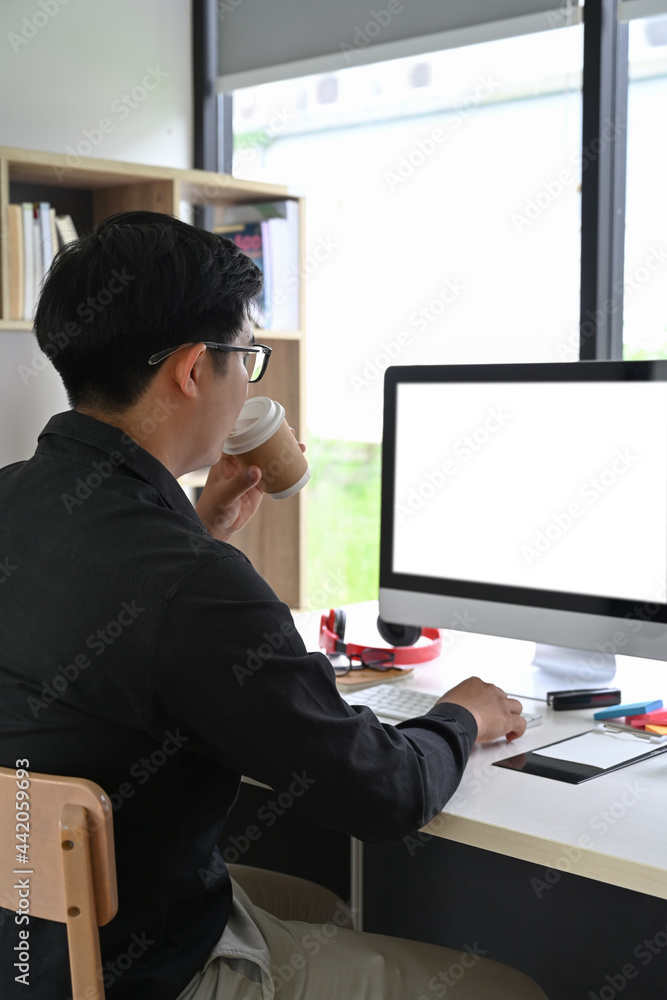 Back view of businessman working with modern gadget in office. Back view of businessman working with modern gadget in office.